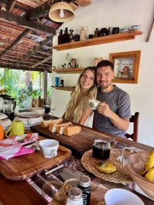a man and woman posing for a picture at a table at Luminosium Nature Retreat & Heritage Forest Garden in Pannala