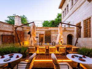 a patio with tables and chairs and a building at Sedirli Konak 1751 Special Class in Ürgüp