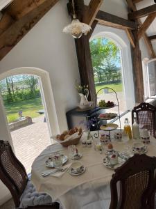 a table with plates and bowls of food on it at B&B De Cootjes in Ossendrecht +21 photos