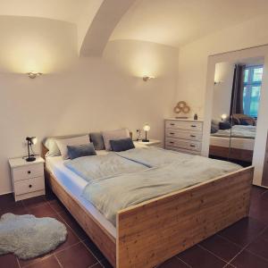 a bedroom with a large wooden bed with a mirror at Apartment Mauthen 19 in Mauthen +35 photos