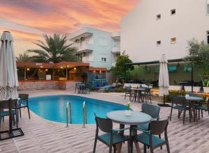 a hotel patio with tables and chairs and a pool at Green Side Leon Hotel in Side