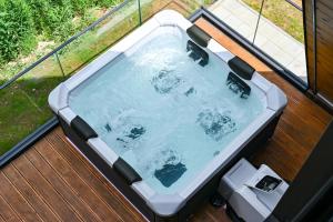 a hot tub sitting on a deck at Tara mountain house Kopaonik in Kopaonik