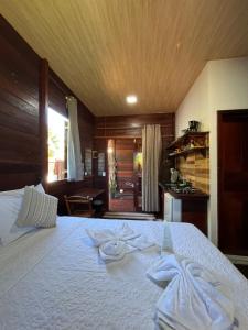 a bedroom with a bed with towels on it at Chalés Paradise in Atins +65 photos