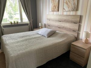 a bedroom with a large bed and a window at Yyterin Meriheinä in Pori