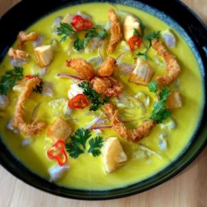 a bowl of soup with shrimp and vegetables on a table at Nau Guest House & Restaurant in Iquitos +2 photos