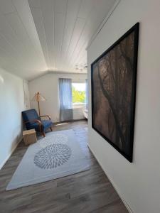 a living room with a large television on a wall at Villa Puutarha, Merikarvia in Merikarvia