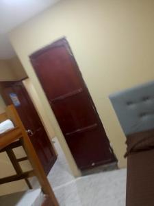 a room with a wooden door in a room at Habitaciones centro Coquerita in Coveñas