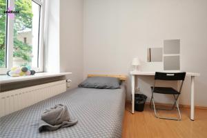 a small bedroom with a bed and a desk at MMRent Divine Room in Gdańsk +12 photos