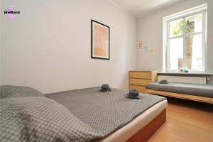 a bedroom with two beds and a window at MMRent Divine Room in Gdańsk