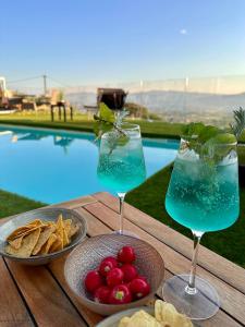 a table with two drinks and chips and a plate of food at Villa Borgo Soale in Reggello