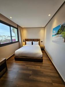 a bedroom with a bed and a large window at Ocean Rooftop Hotel in Ben Slimane +58 photos