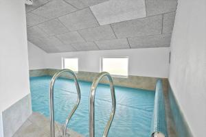 a swimming pool with two metal rails in a room at FY131-Middelfart-Stjernevej-111 in Middelfart