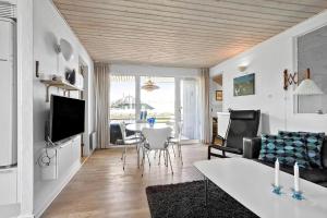 a living room with a couch and a table at FY131-Middelfart-Stjernevej-111 in Middelfart