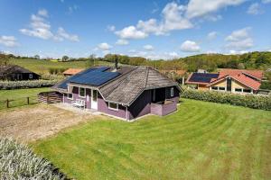 a house with solar panels on top of a yard at FY131-Middelfart-Stjernevej-111 in Middelfart