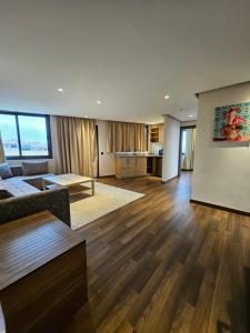 a living room with a couch and a table at Ocean Rooftop Hotel in Ben Slimane