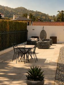 a patio with a table and chairs on a patio at A Capela - A Essência de Sintra in Sintra
