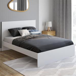 a bed in a white room with a mirror at Dar Mustapha in Tunis