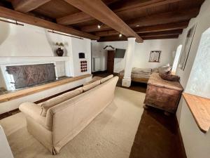 a living room with a couch and a fireplace at Stallrefugium - between lakes, mountains and silence in Seeon-Seebruck