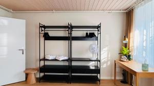 a black bunk bed in a room with a desk at 130sqm Duplex with AirC - Gratis Parking - Familie Freunde - See und Jura in Biel +33 photos