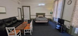 a living room with a couch and a bed at County Studio in Ipswich