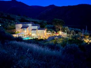 a view of a house at night with lights at Villa Borgo Soale in Reggello