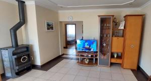 a living room with a television and a stove at Ruža Vacation House in Međugorje