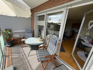 a patio with a table and chairs on a balcony at Ostseeliebe in Grömitz