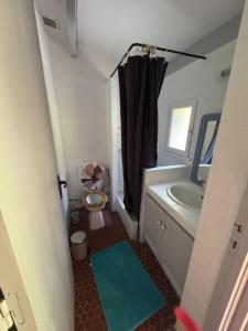 a small bathroom with a toilet and a sink at Le Souffle des Cévennes in Saint-Étienne-Vallée-Française
