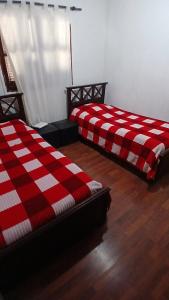 two beds sitting next to each other in a room at Temporario balcarce in Santo Tomé +3 photos