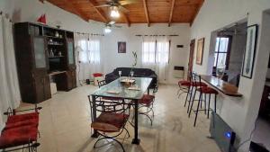 a living room with a table and some chairs at Temporario balcarce in Santo Tomé