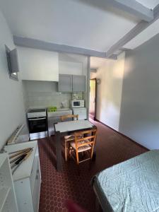 a small kitchen with a table in a room at Le Souffle des Cévennes in Saint-Étienne-Vallée-Française +38 photos