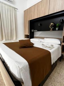 a bedroom with a large bed with a large headboard at AG SUITE TRAPANI in Trapani