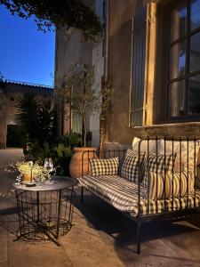 a couch and a table on a patio at Les Tilleuls in Cavaillon +38 photos