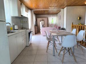 a kitchen and dining room with a table and chairs at Afroditi Country Residence in Oropos