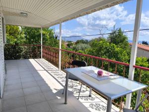 a white table on a balcony with a view at Afroditi Country Residence in Oropos