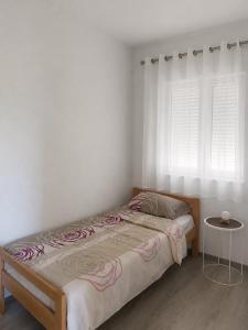 a bedroom with a bed and a table and windows at Vila Lana in Trebinje +11 photos
