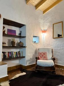 a chair with a pillow sitting in a room at Sagres, Aloha Beach House, 500 meters from Tonel beach in Sagres