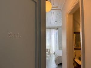 a hallway with a mirror and a room with a bed at Gule Cunda in Ayvalık +85 photos