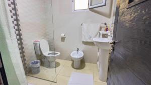 a small bathroom with a toilet and a sink at Apartamento de lujo Martil in Martil +9 photos