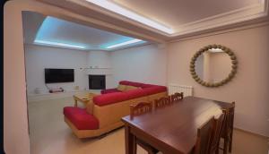 a living room with a couch and a table at Portside Living in Sarandë