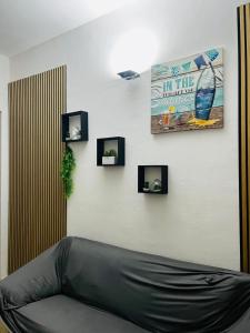 a living room with a black couch on a wall at AG SUITE TRAPANI in Trapani