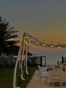 a table set up for a wedding on the beach at Villa Marnero in Grigoleti