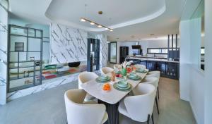 a dining room with a table and white chairs at Villa Infinity Sky - Private Pool - Panoramic Sea View in Kaş
