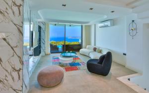 a living room with a couch and a table at Villa Infinity Sky - Private Pool - Panoramic Sea View in Kaş