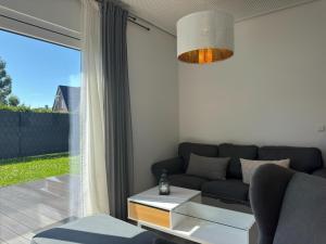 a living room with a couch and a window at Moderne Ferienwohnung mit Sauna & Terrasse in Burhave