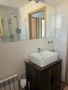 a bathroom with a white sink and a mirror at Apartament Color4you Blue in Wschowa