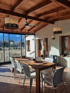 a dining room with a wooden table and chairs at Tafi del Valle Casa Kabure in Tafí del Valle