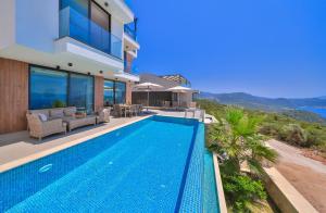 a villa with a swimming pool and a house at Villa Infinity Sky - Private Pool - Panoramic Sea View in Kaş