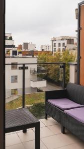 a balcony with a bench and a view of a city at BEMO Apartment in Warsaw