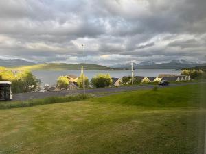 a view of a lake and a road with a car at Cozy apartment with two bedrooms in Tromsø